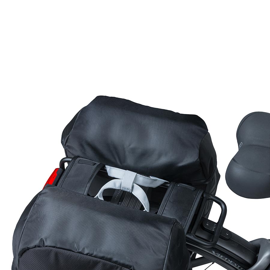 Black Basil Miles panniers mounted on a bicycle, showcasing durable waterproof fabric and secure attachment system.
