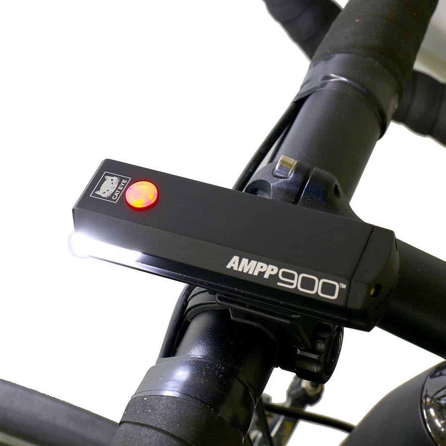 CatEye AMPP900 bike light showing its compact design and bright LED illumination for nighttime visibility.