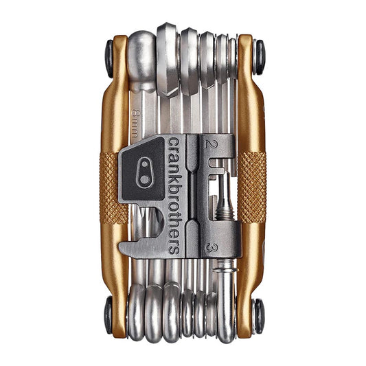 Crankbrothers Multi 19 multi-tool in black and red with various bike repair tools laid out on a white background.