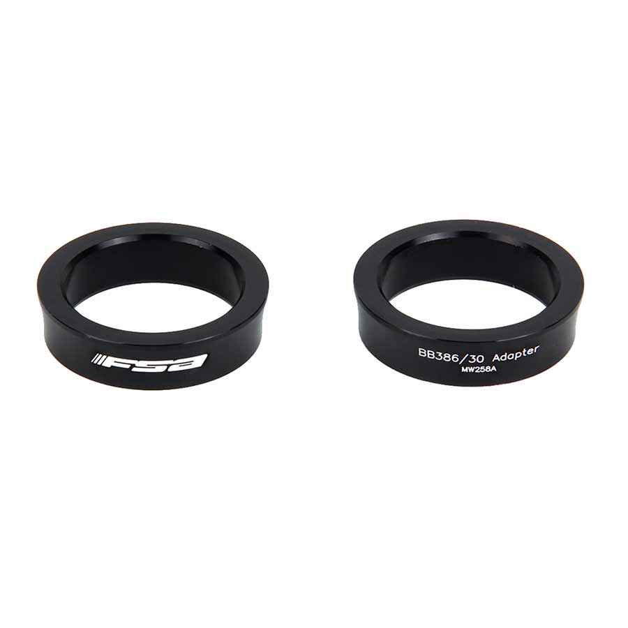FSA 386 EVO bottom bracket adaptors for BB-PF30, showing the black metal adapters with threading and branding details.