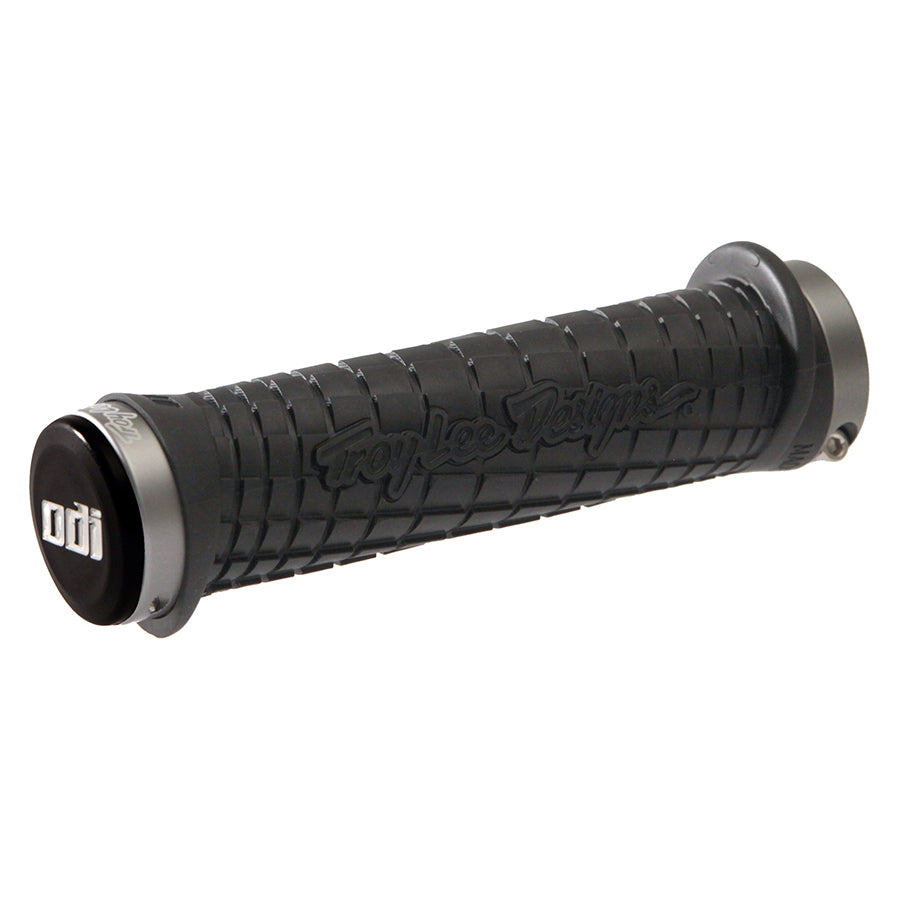 Black and gray ODI grips with Troy Lee Design branding, designed for enhanced grip and comfort on bike handlebars.