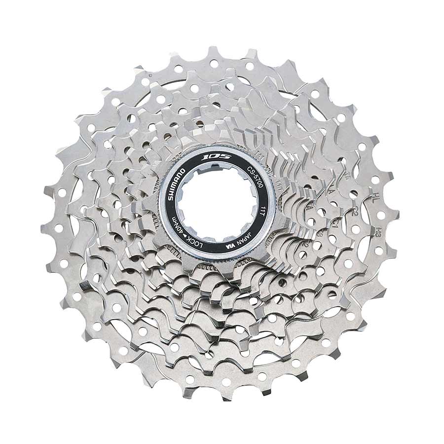 Shimano CS-5700 11-25T cassette with 11-25 tooth gears, shown in close-up with metallic finish and gear teeth detail.