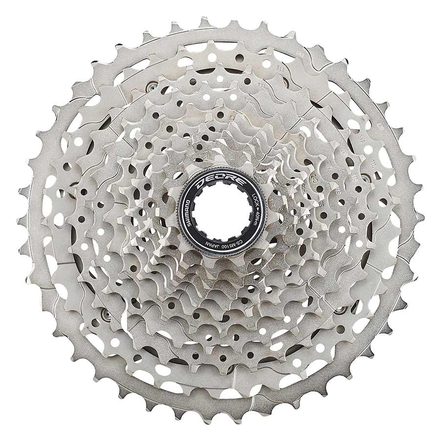 Shimano CS-M5100-11 cassette with 11-42T gear ratio, showing shiny metal cogs and black body for mountain bike gearing
