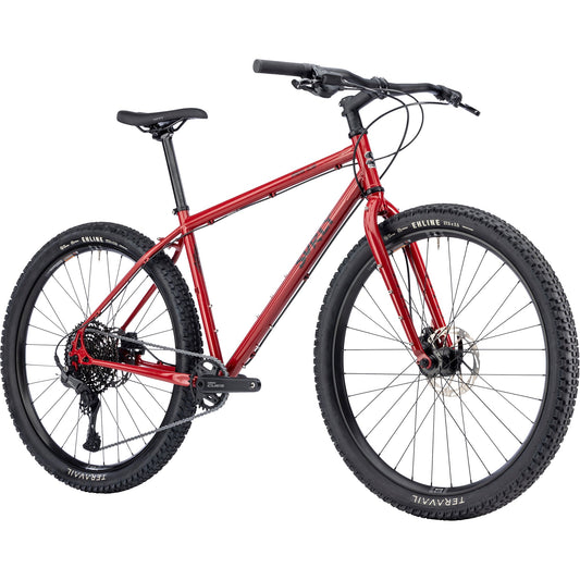 Surly Bridge Club gravel bike in lingering cranberry color with 27.5-inch wheels, featuring a sturdy frame and off-road tires.