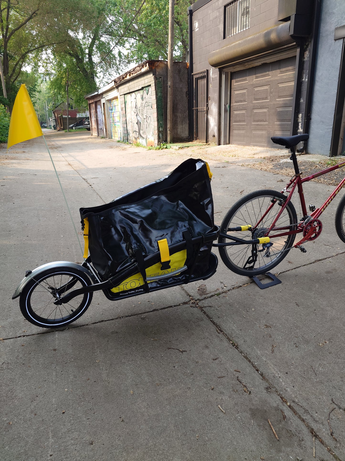 Topeak Journey TX Thru-Axle Trailer attached to a bicycle, designed for easy hauling and transport.