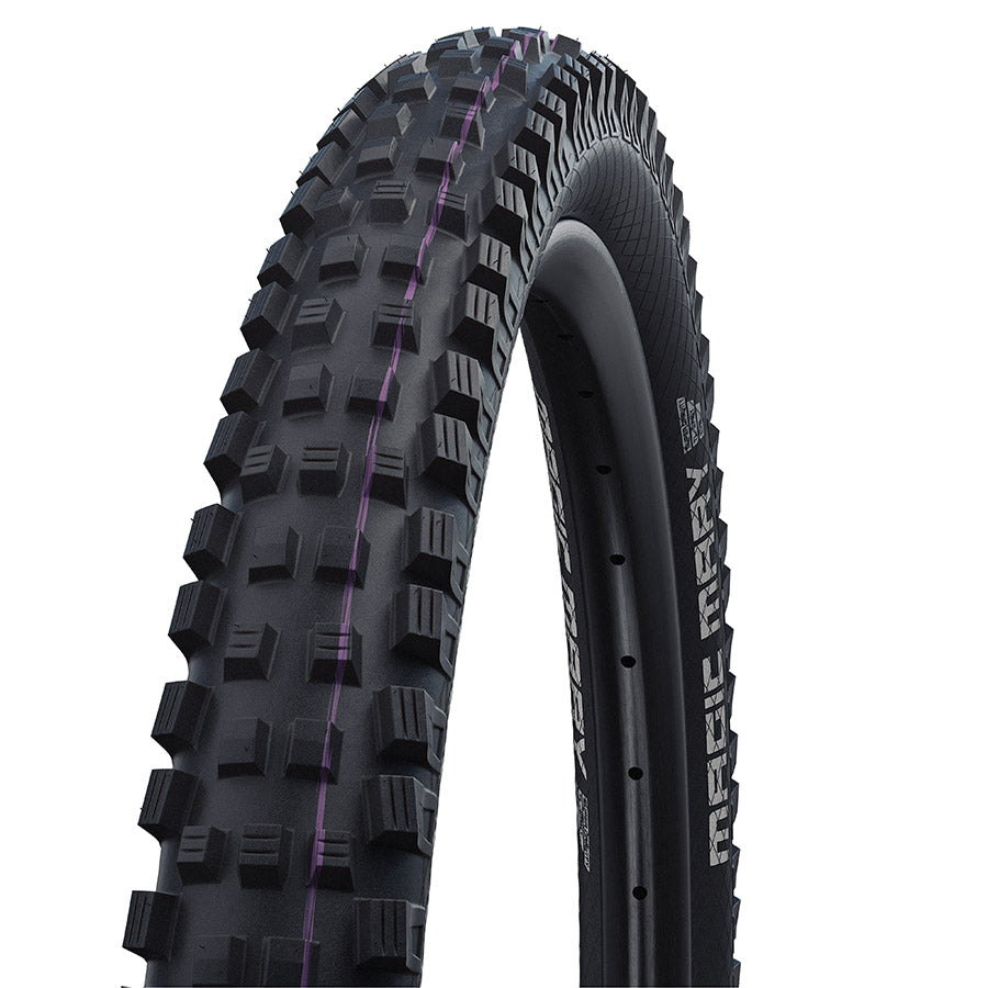 Schwalbe Magic Mary Gravity mountain bike tire with knobby tread for off-road riding, shown in close-up with black rubber and sidewall details.