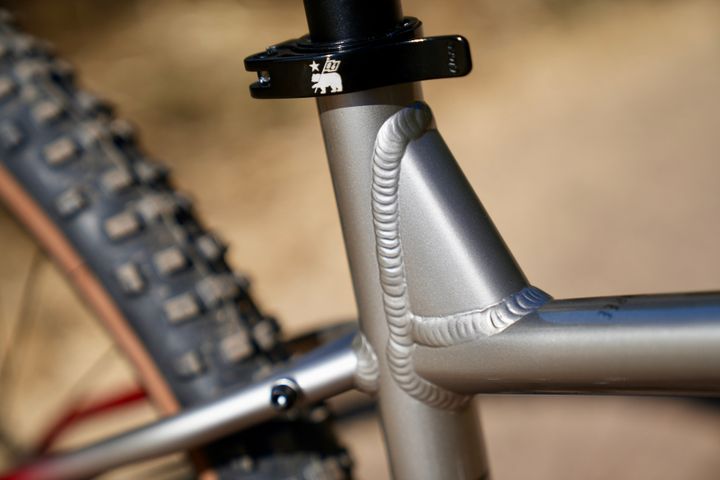 Close-up of Marin Bobcat Trail 3 mountain bike frame with detailed components and branding in a natural outdoor setting.
