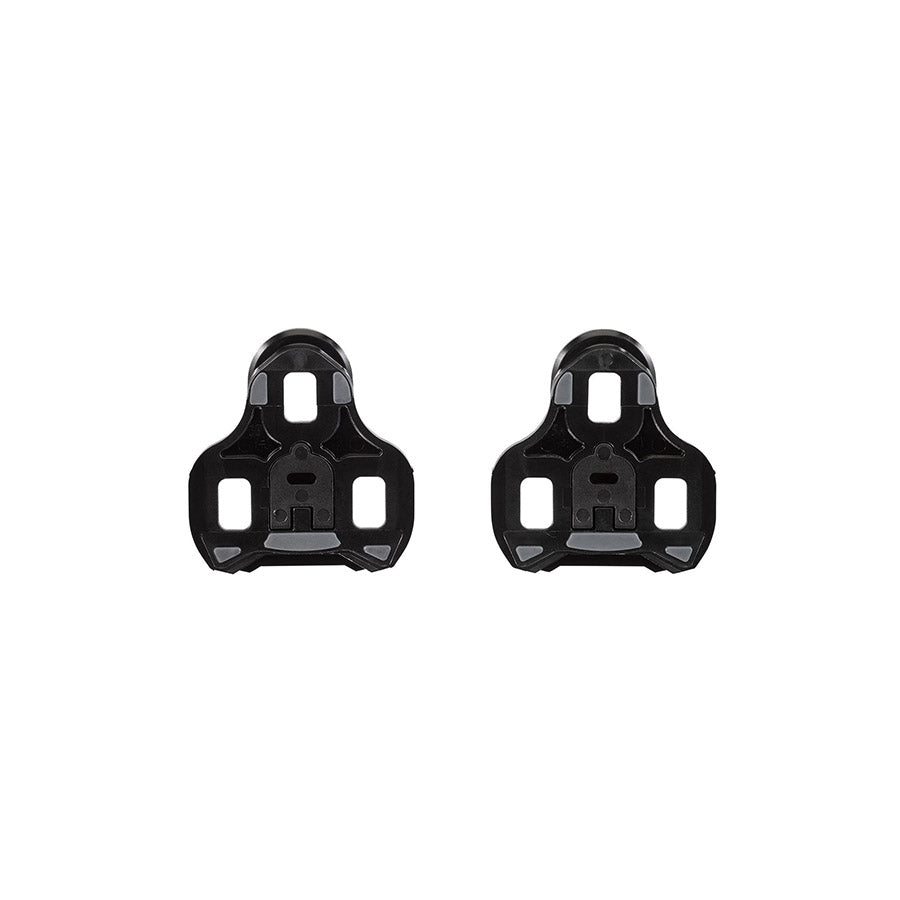 Look Keo Grip 0° black cycling cleats attached to cycling shoes, showing secure clip mechanism for pedal compatibility.