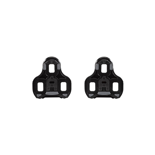 Look Keo Grip 0° black cycling cleats attached to cycling shoes, showing secure clip mechanism for pedal compatibility.