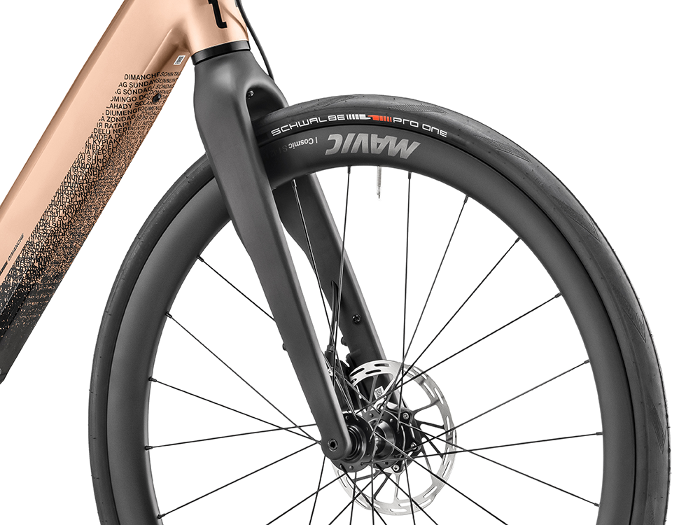 Close-up of the fork detail on a Moustache Dimanche 28 Road 6 electric bicycle, showcasing its sleek frame and high-quality build.