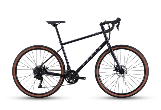 Marin Four Corners 1 gravel bike with purple frame and drop handlebars, shown in profile view.