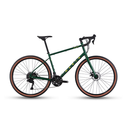 Green Marin Four Corners 1 gravel bike with cues, shown from a profile view highlighting frame and tire details.