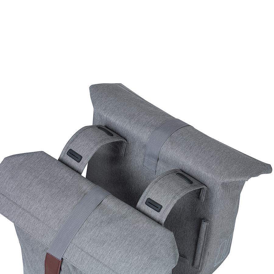 Black Basil City panniers attached to a bicycle, showcasing durable waterproof bags for urban commuting and storage.