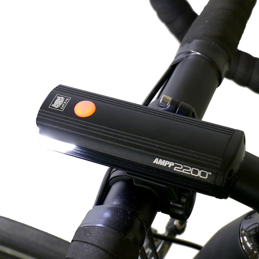 CatEye AMP P2200 bike light showing front view with bright LED beam and compact design for cycling safety.