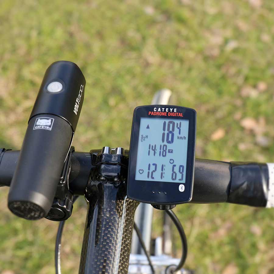 CatEye Padrone Digital bike computer in black showing GPS display, cadence, and optional heart rate monitor connection.
