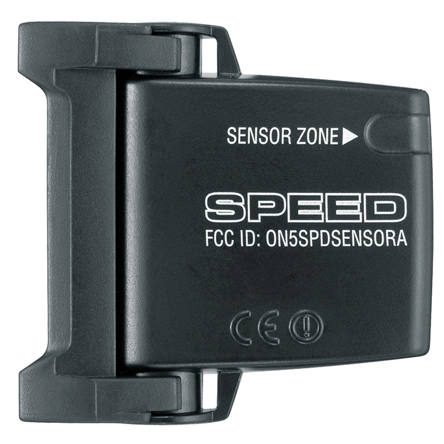 Black CatEye Strada Slim computer mounted on a road bike handlebar, showing digital display and sensor in a natural outdoor setting.