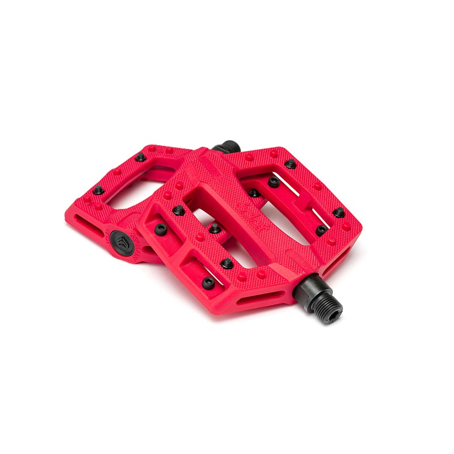 Pair of black Eclat Contra platform pedals with metal pins for BMX or mountain biking, shown from a side angle.