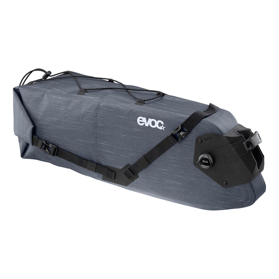 EVOC Seat Pack Boa WP 12L carbon grey seat bag attached to a bike, waterproof design with secure strap for cycling gear storage.