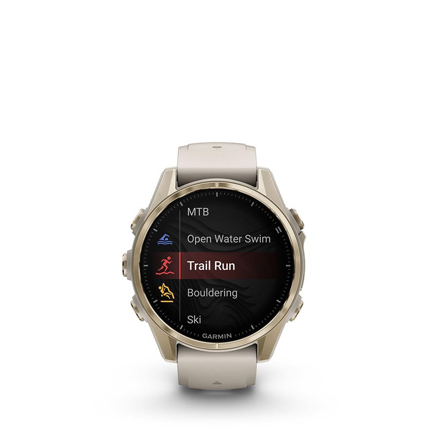 Garmin Fenix 8 AMOLED Sapphire 43mm smartwatch with grey silicone wristband and black pebble-gray bezel on a wrist.