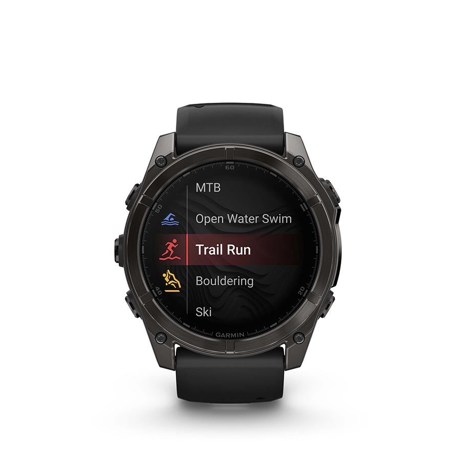 Garmin Fenix 8 AMOLED Sapphire 51mm smartwatch with grey silicone wristband on a person's wrist, black bezel and pebble gray face.