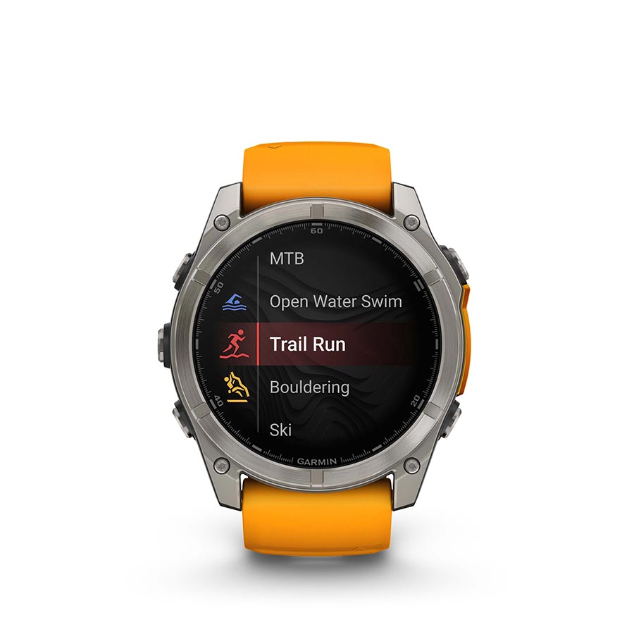 Garmin Fenix 8 AMOLED Sapphire 51mm watch with grey silicone wristband and black pebble face on a person's wrist.
