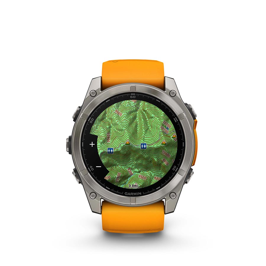 Garmin Fenix 8 AMOLED Sapphire 51mm watch with black pebble gray silicone strap on a grey wrist, showcasing its sleek design.