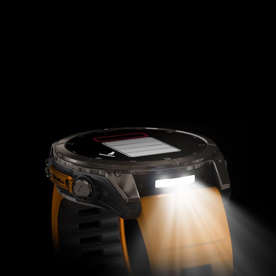 Garmin Fenix 8 AMOLED Sapphire 51mm smartwatch with grey silicone strap on a wrist, black bezel, and pebble gray dial.