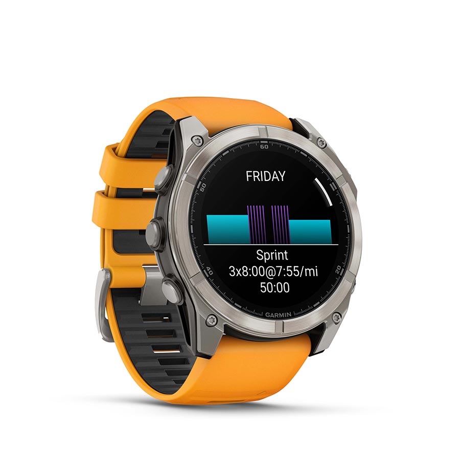 Garmin Fenix 8 AMOLED Sapphire 51mm watch with black Pebble Gray silicone wristband and display on a grey wrist.