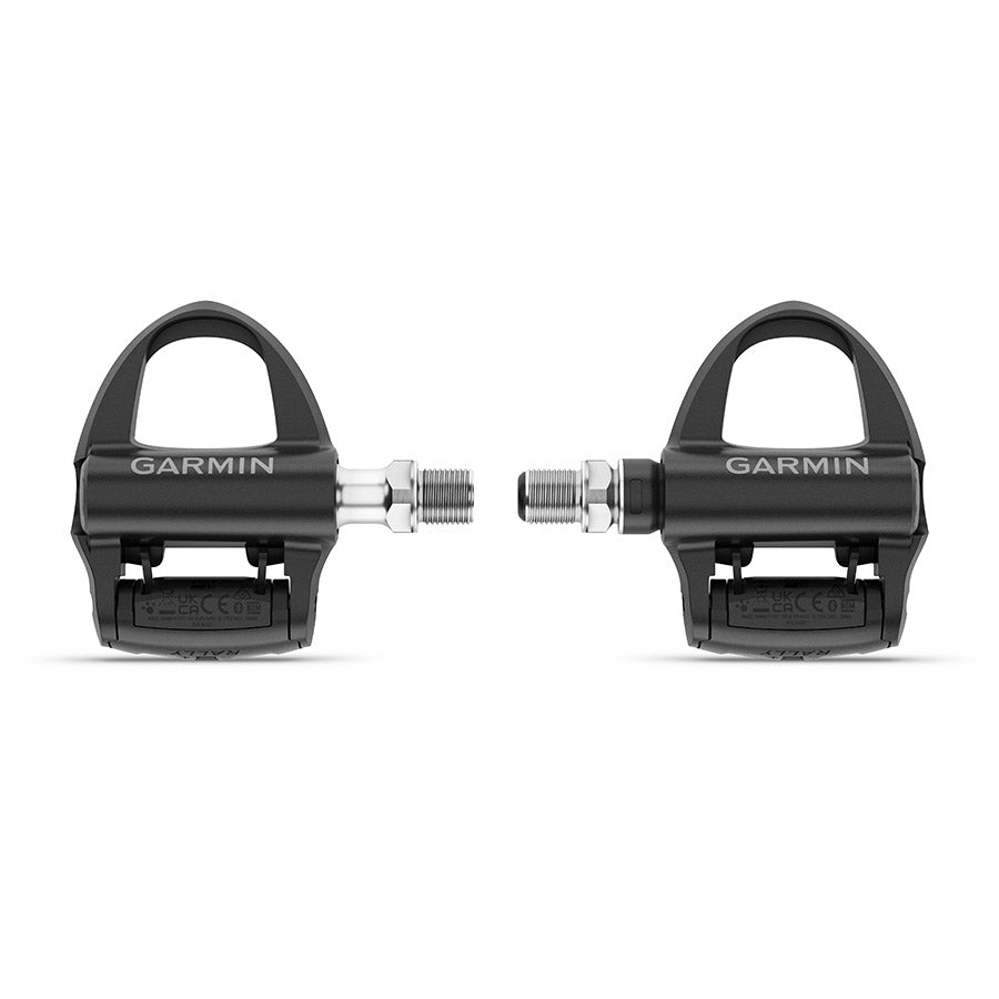 Garmin Rally RS clipless road pedals with black composite body and stainless steel spindle, single-sided design for cycling.