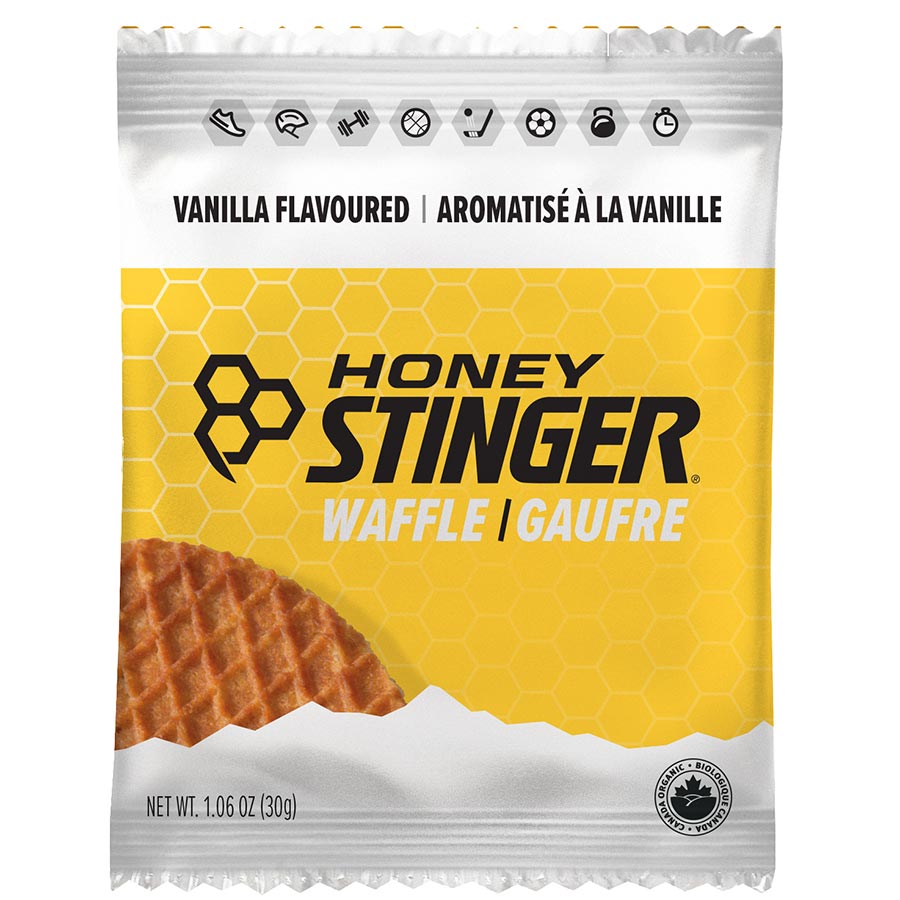 Organic Honey Stinger waffle bars, 12-pack, showing golden, honey-flavored waffle bars in clear packaging.