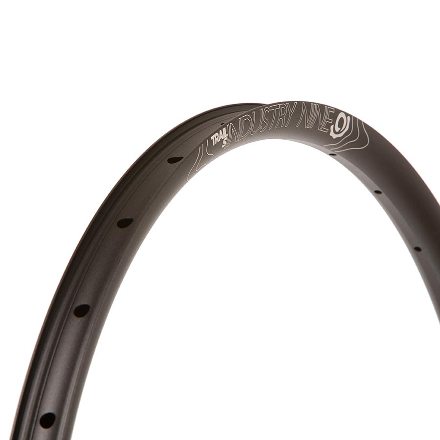 Black Industry Nine Trail S 27.5-inch rim with 28 holes, designed for mountain biking and durable performance.