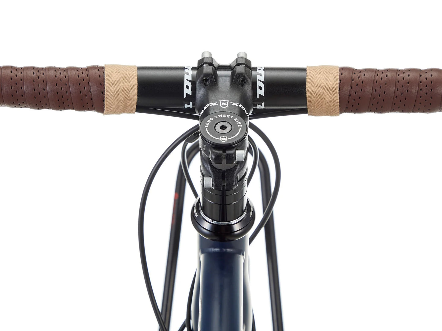 Kona Sutra touring bike with drop handlebars, sturdy frame, and multiple gears, designed for long-distance cycling adventures.