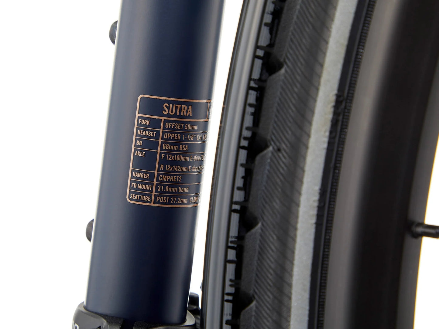 Kona Sutra touring bike with black frame, equipped with front and rear racks, ready for long-distance cycling adventures.