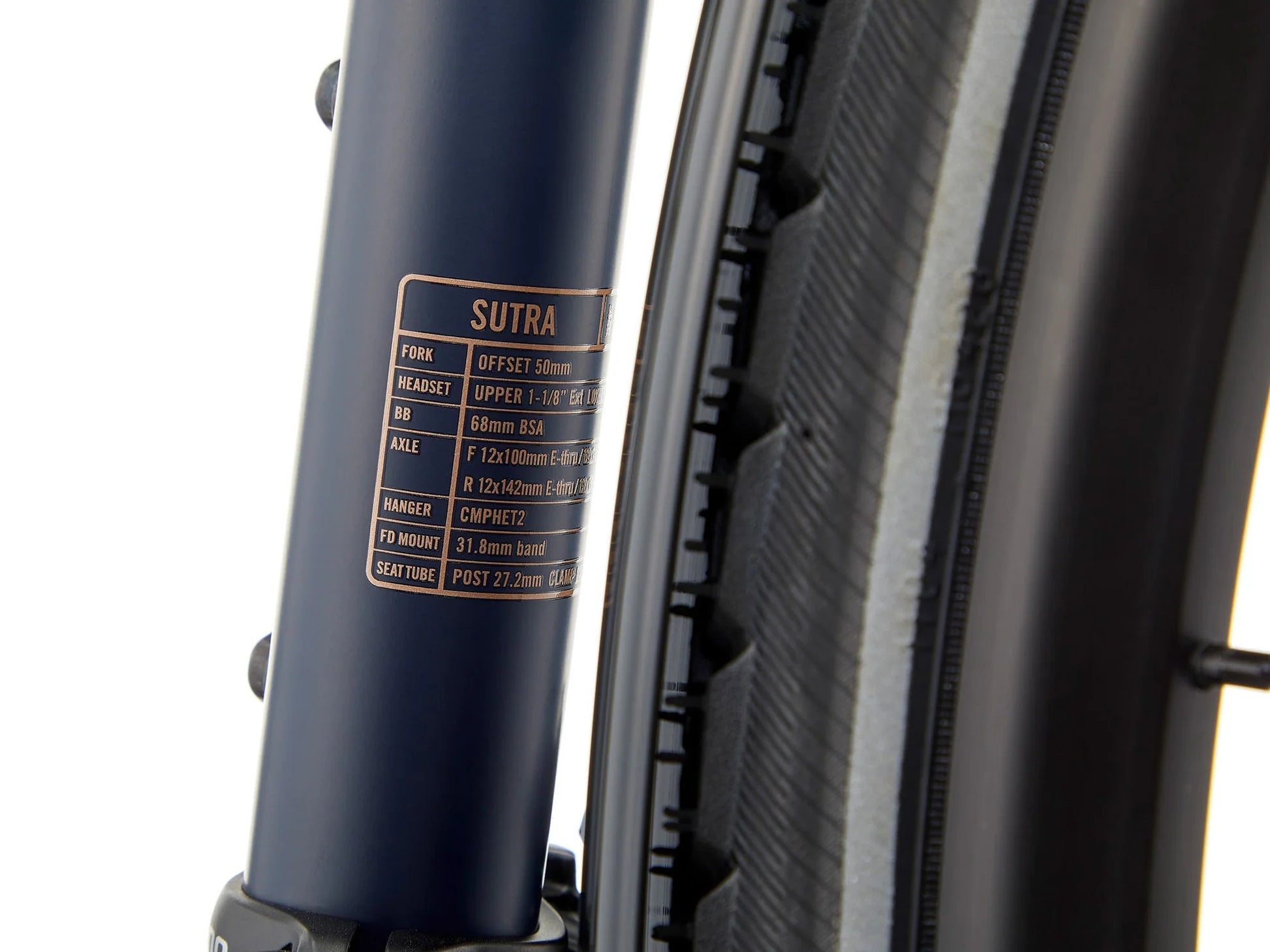 Kona Sutra touring bike with black frame, equipped with front and rear racks, ready for long-distance cycling adventures.
