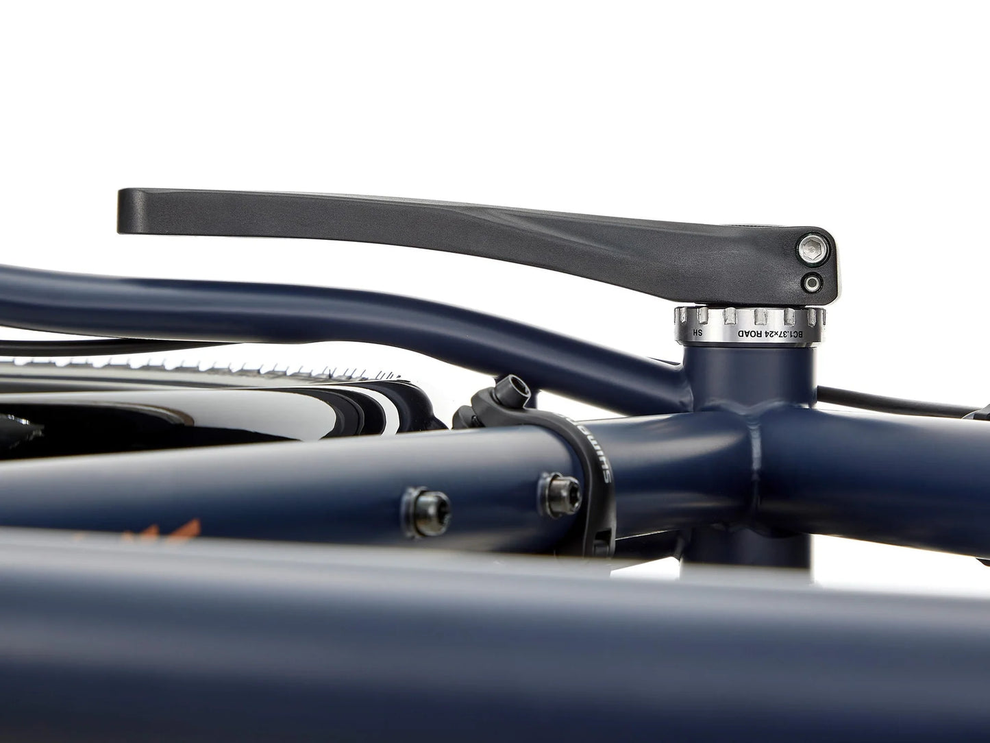Kona Sutra touring bike with black frame, drop handlebars, and panniers mounted on rear rack, ready for long-distance cycling.