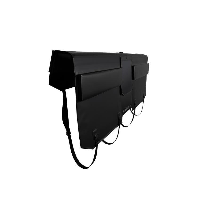 Kuat Huk Tailgate Pad for truck bed racks, curved design, black with Kuat branding, mounted on a truck tailgate