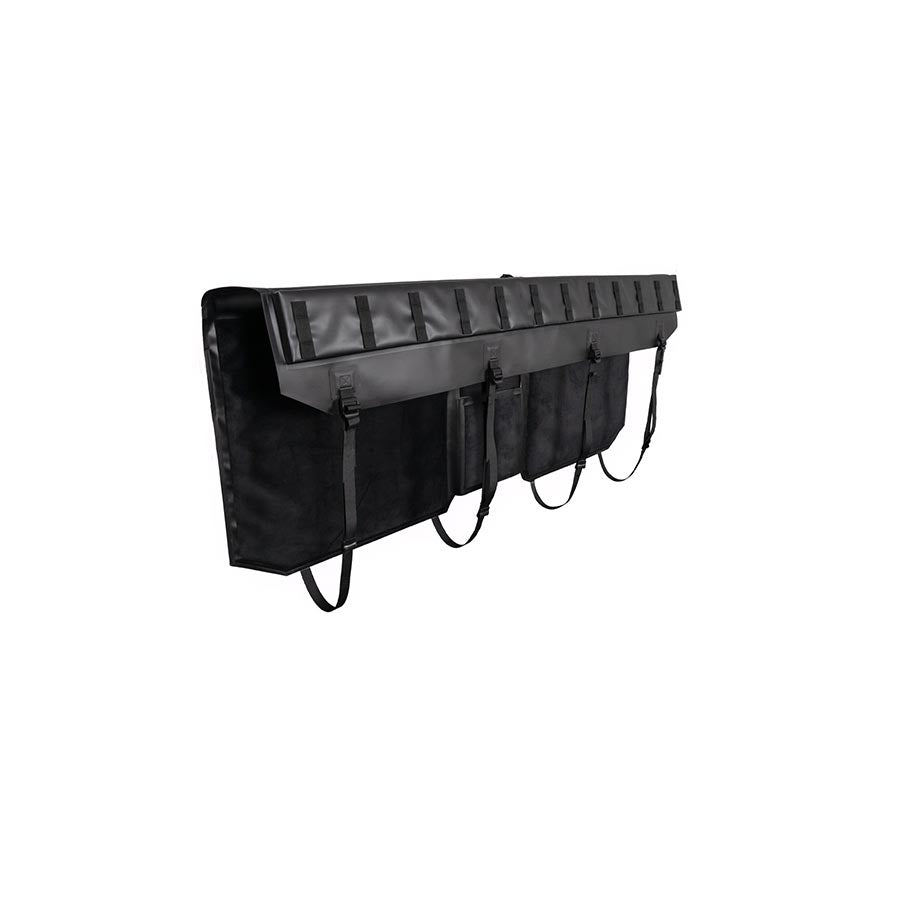 Kuat Huk tailgate pad for truck bed racks, curved design, black fabric with straps and buckles, securing gear on truck tailgate.