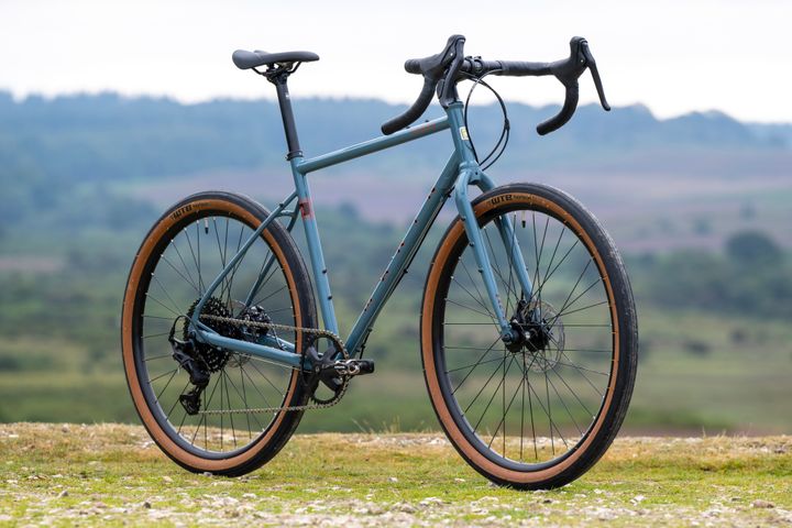 Grey Marin Nicasio+ gravel bike with 50cm frame, shown from side view, highlighting its frame and tire details.