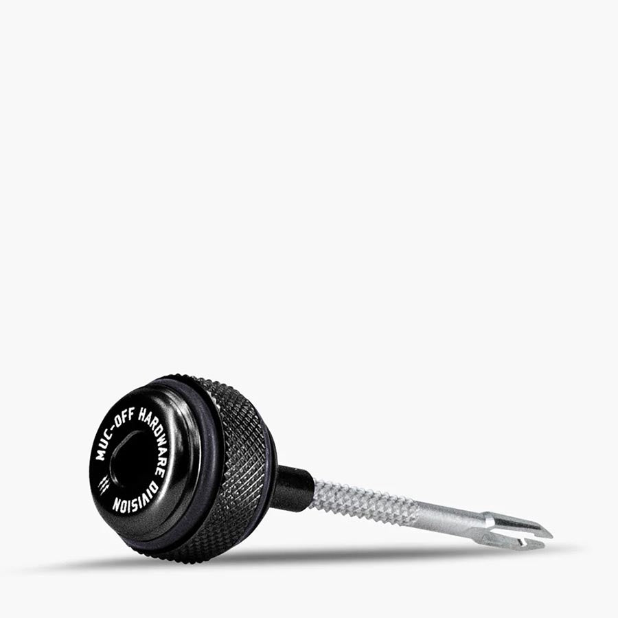 Pink Muc-Off Precision Tubeless Capsule for tubeless tire repair, showing the compact repair product with branding.