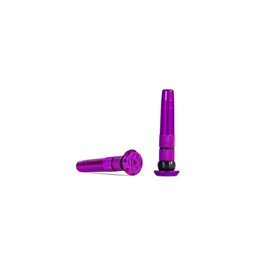 Pair of Muc-Off Stealth Tubeless Plugs for tubeless tire repair, black, durable rubber design for quick sealing.