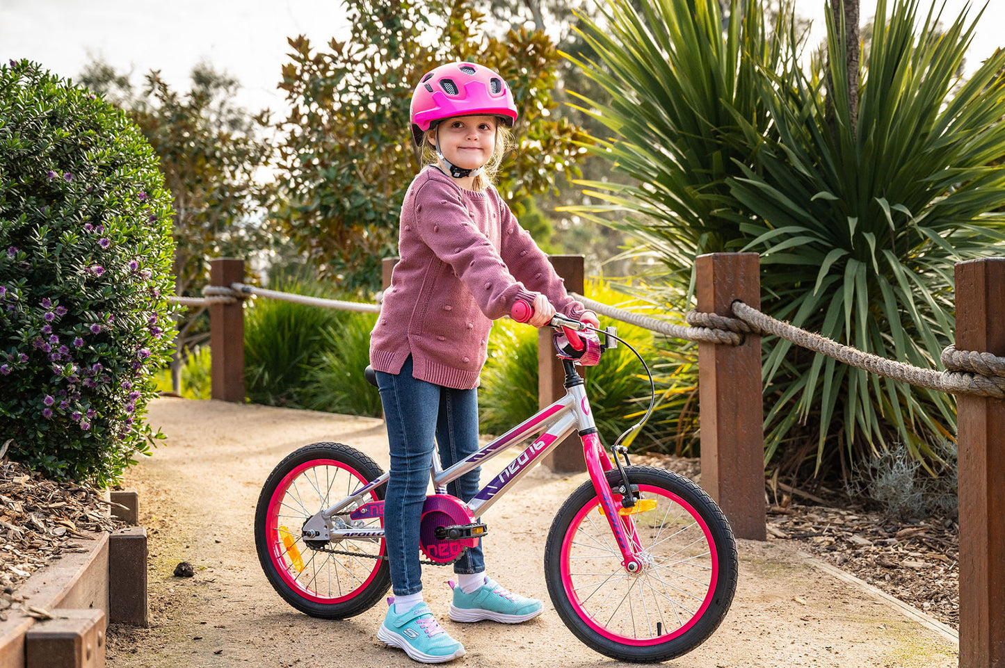 Neo+ 16-inch girl's kids bicycle featuring a colorful frame and training wheels, designed for young children learning to ride.