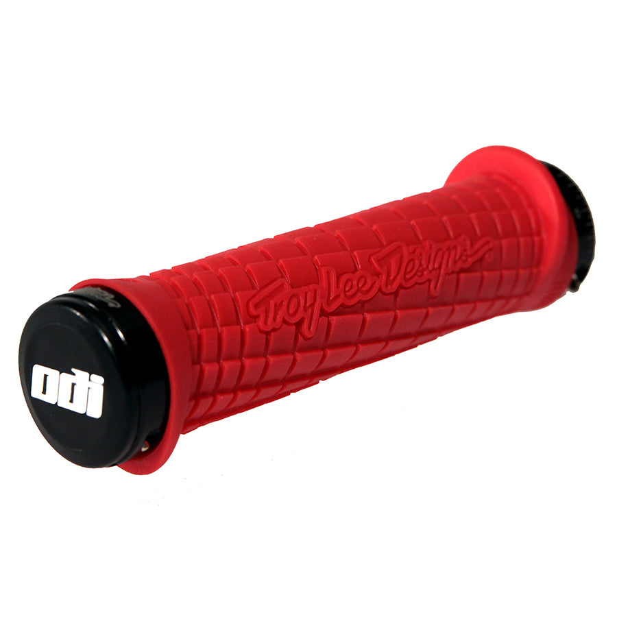 Black and gray ODI grips featuring Troy Lee Design branding, designed for comfortable bike handling and enhanced grip.
