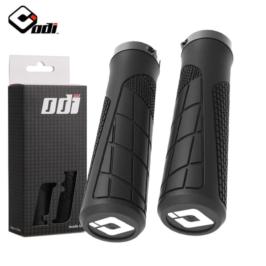 Black ODI clamp-on rubber grips for bicycles, featuring textured surface for improved grip and comfort.