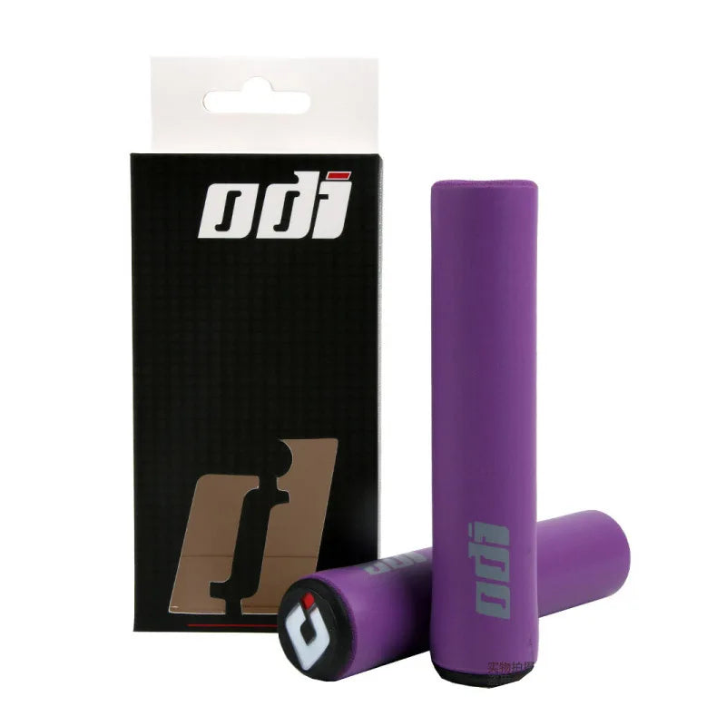 Black ODI silicone grips for bicycles, showing textured surface and secure fit for enhanced grip and control.