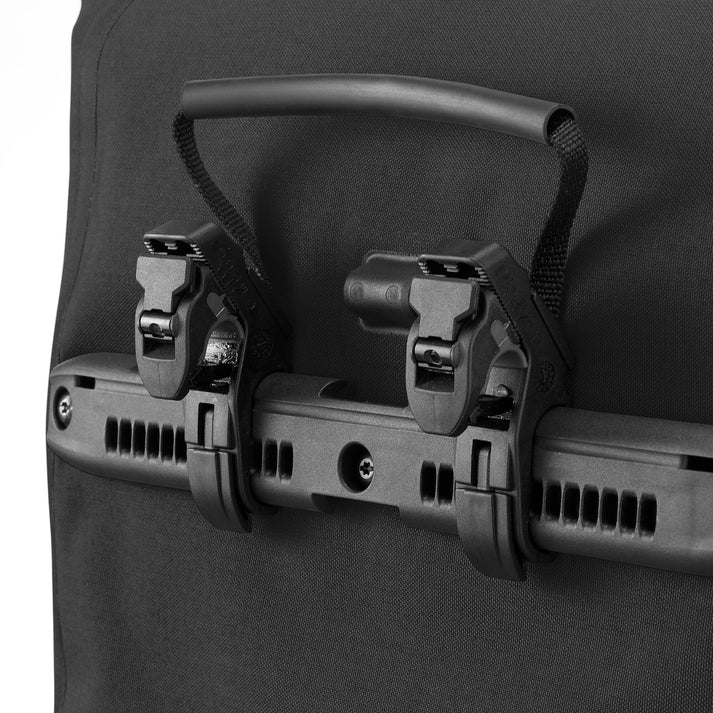 Ortlieb Urban Vario PS QL3.1 26L panniers attached to bicycle rack, waterproof bike storage with adjustable straps.