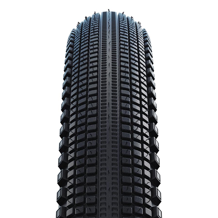Schwalbe G-One Comp gravel tires with 28x1.35 size, black with green compound and K-Guard protection, mounted on a wheel.