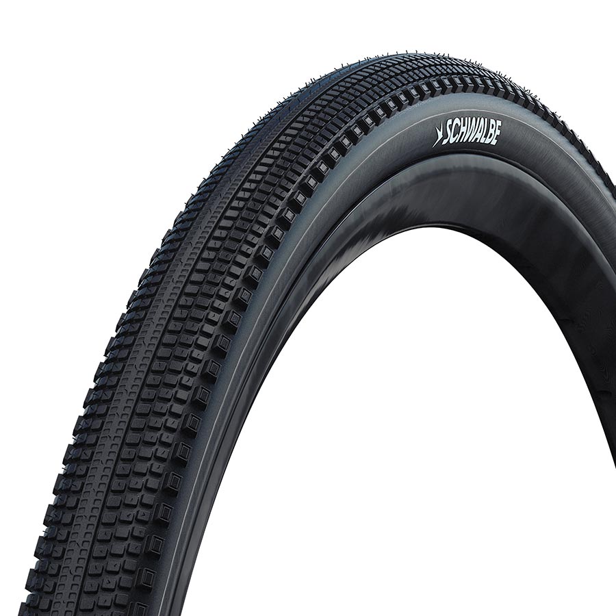 Schwalbe G-One Comp gravel tires 28x1.35 with green compound and K-Guard protection, shown in black on a bike wheel.