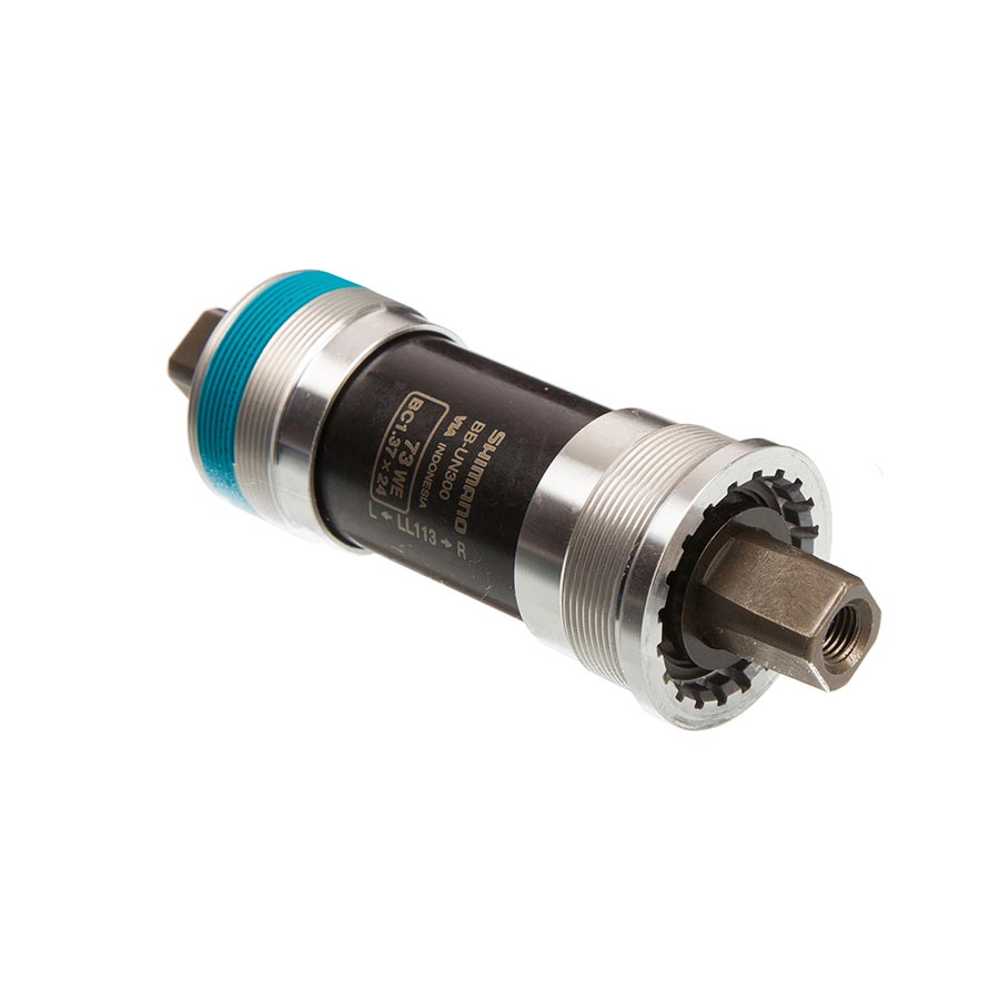 Shimano BB-UN300 square taper bottom bracket in silver, 68mm spindle width, for bicycle cranksets, close-up of the product.