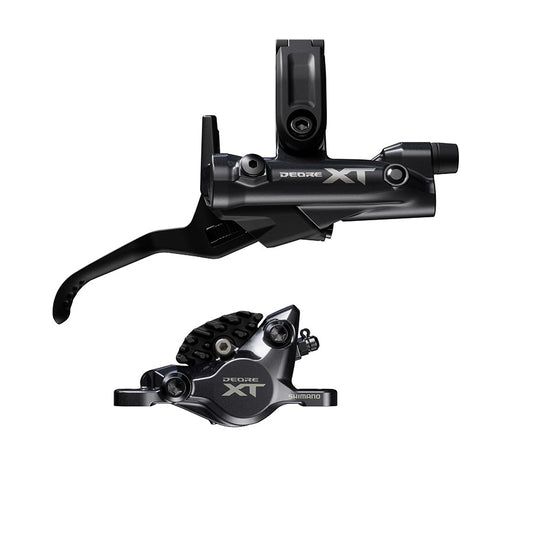 Shimano Deore XT M8200 MTB hydraulic disc brake set with left black brake lever and caliper on a mountain bike.