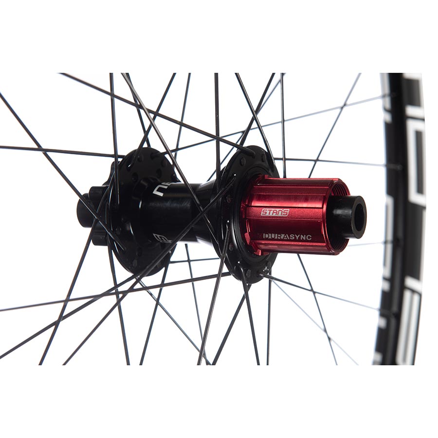 Front view of Stans No Tubes Flow EX3 27.5-inch mountain bike wheels with 32 spokes, boost disc mount, and 15mm thru-axle.